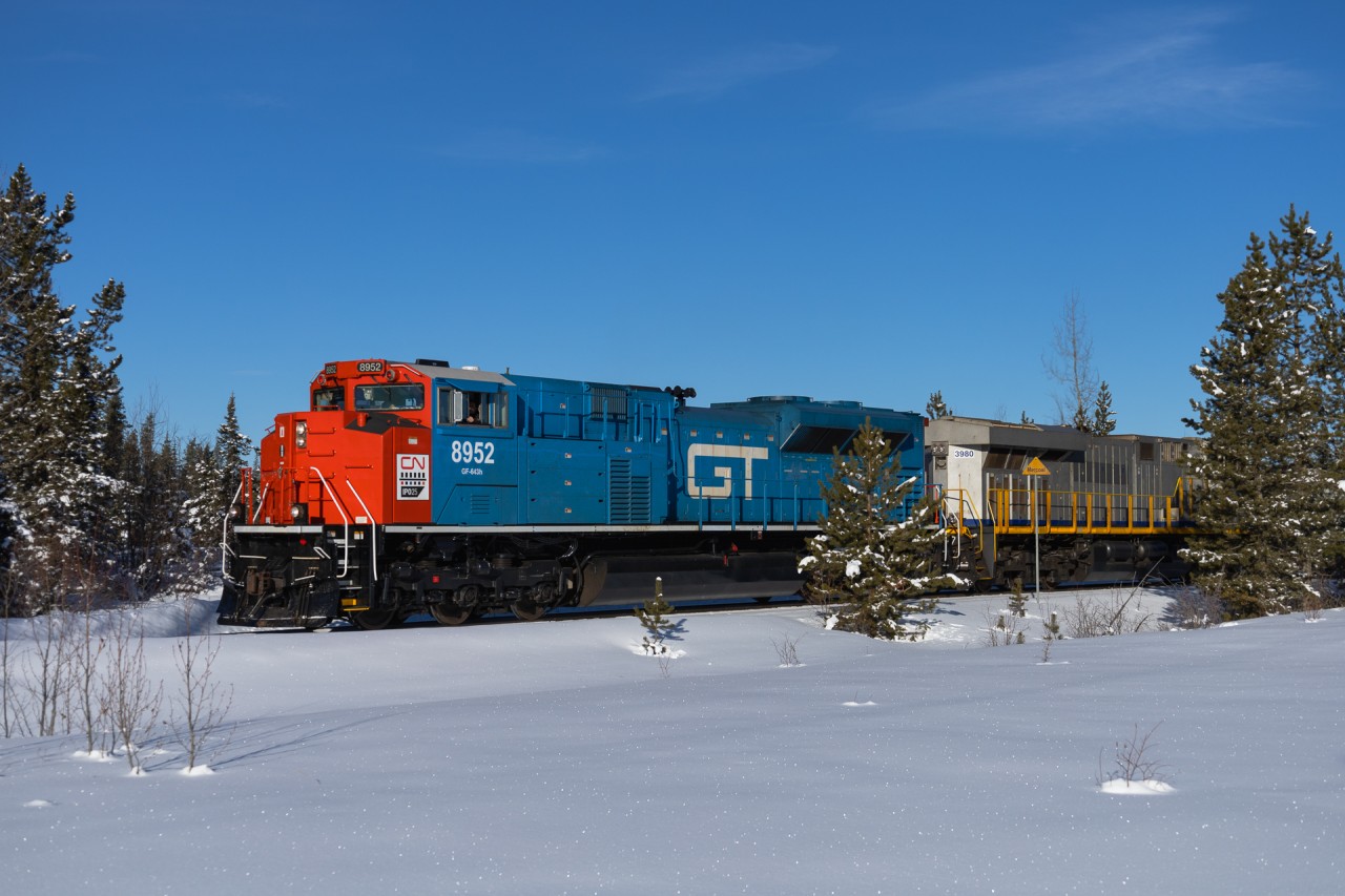 It is currently +31 in Edmonton, but soon the weather will turn and scenes like this will be common again.  The GTW Heritage unit leads Edmonton to Cadomin stone train U 72552 25 past the one mile to station sign at Mercoal, on the isolated Mountain Park Spur.  It turned out that the line was tough to chase, with very few access points, however it was a nice drive along Forestry Trunk Roads on a warm February morning.