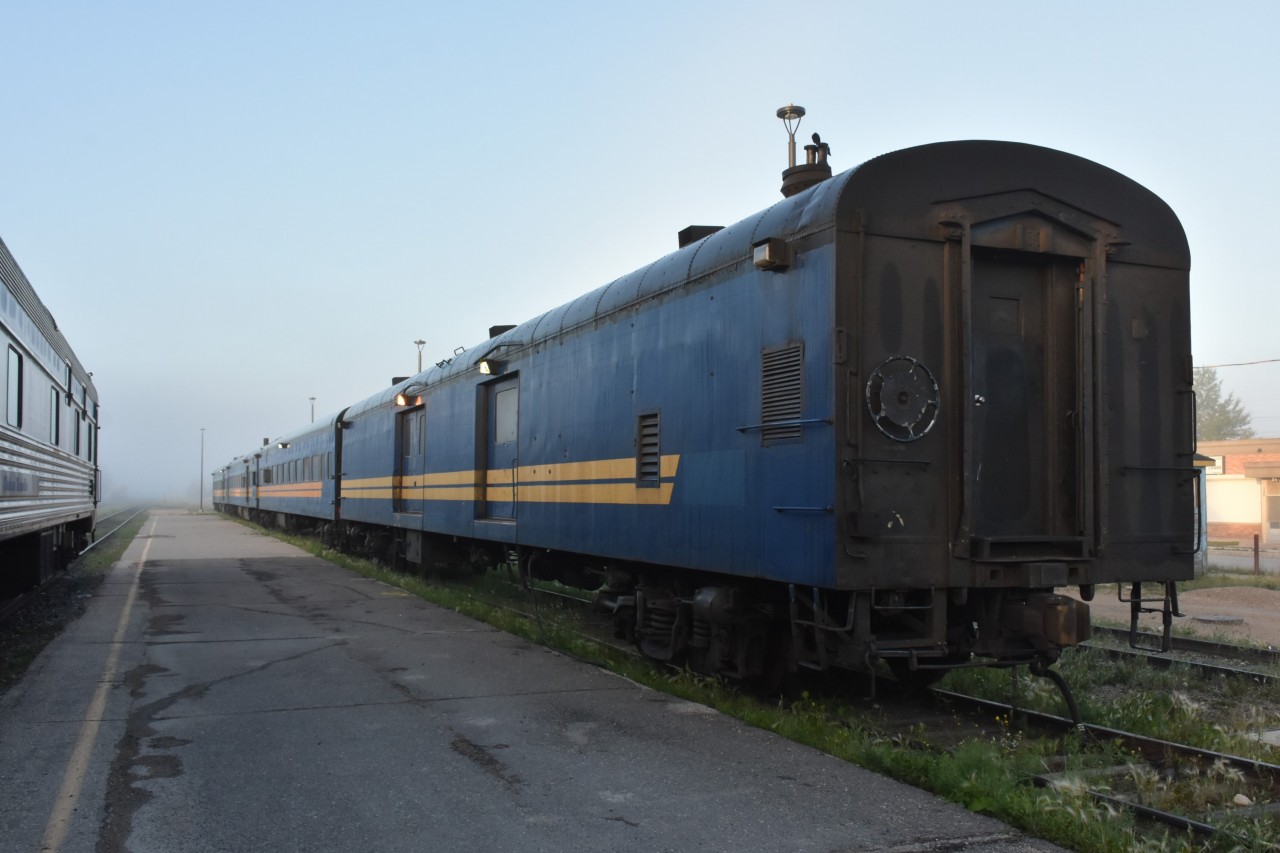 I didn't make it to Pukatawagan on my recent journey from Winnipeg to Churchill, MB, but I did manage to get an early morning shot of the HBR's Pukatawagan Mixed passenger equipment parked on a stub track at the south end of the station in The Pas, MB. It was cool, damp, and quite foggy when I first stepped off VIA 693 at 06:25 on this August 1st morning but as soon as the sun poked out of the clouds the mist cleared a little allowing me to get this tight view of the ex-VIA, exx-CN cars.