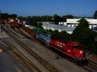 An extra with a nice lashup of CP 4429 & CMQ 3812 is shoving a long string of well cars into the Lachine IMS Yard.