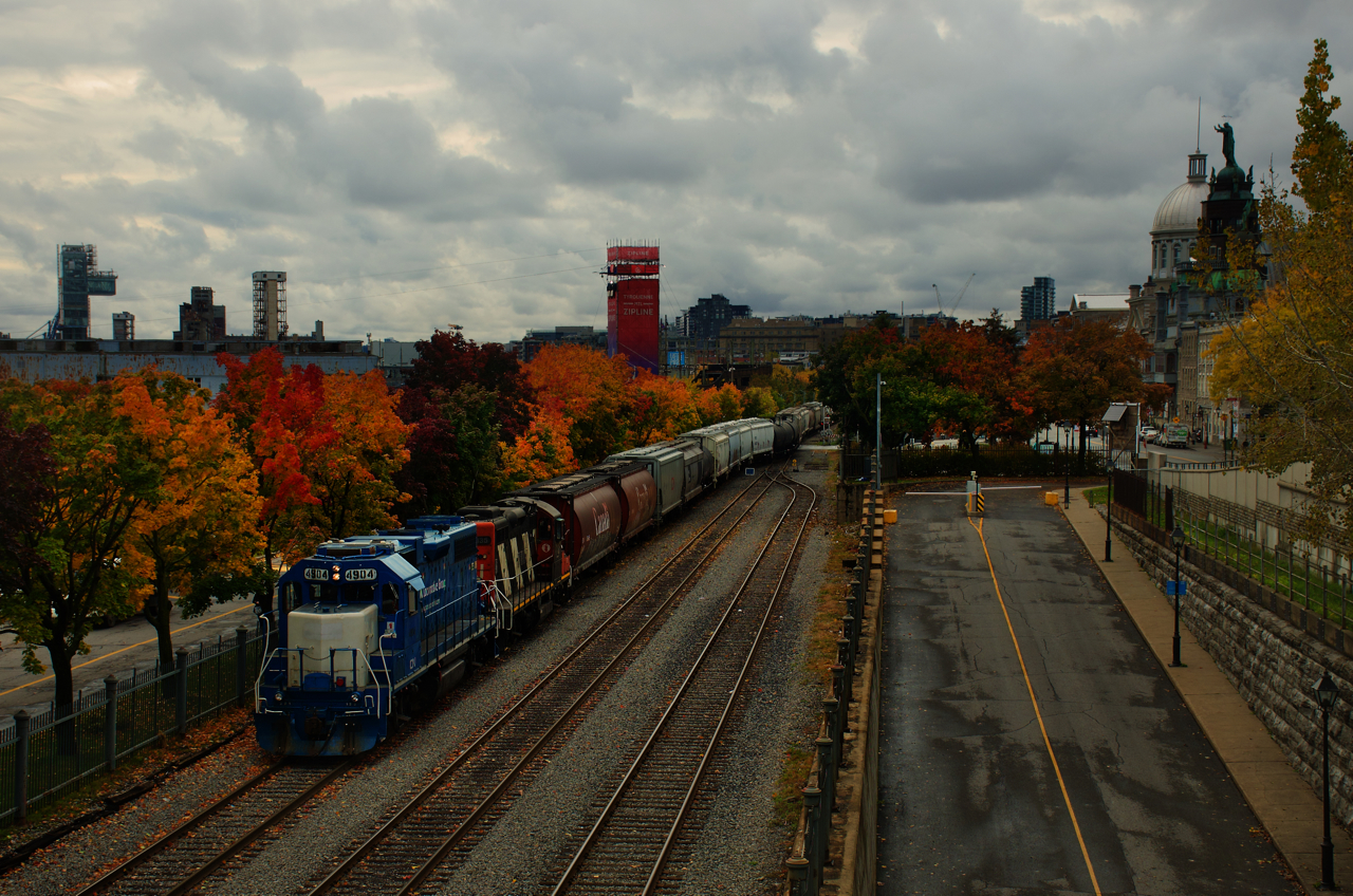 CN 500 is inbound into the Port of Montreal with a decent sized train as it passes some nice fall colours. At right are two Old Montreal landmarks: the Bonsecours Market and the Notre-Dame-de-Bon-Secours Chapel.