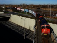 CN 324 is leaving the St-Hyacinthe Sub and heading south on the Rouses Point Sub as it crosses Route 116 with CN 2998 & CN 3059.