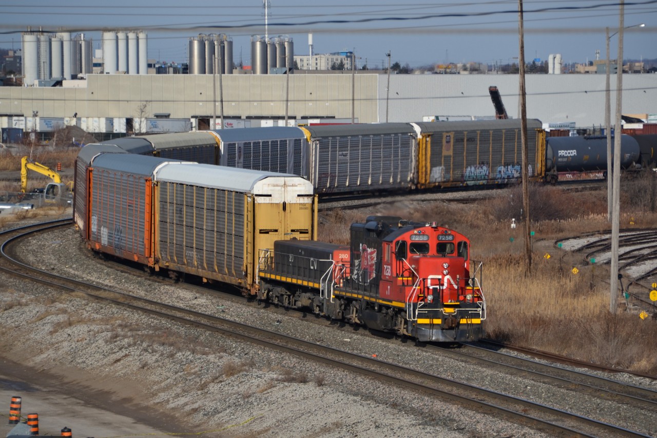 CN 7258, a venerable GP9RM decked out with IPO 15 prints from 2010, hauls a long cut of cars south as it flat switches the west end of MacMillan Yard north of Toronto on a chilly December morning. The IPO 15 stickers, highlighting 15 years of CN being a publicly traded company, sport an SD70I while this print was ironically never applied to one, being featured solely on 7258 and a handful of Dash 8s. More recently, CN introduced a small fleet of heritage units in 2020 to celebrate the 25th anniversary of this occasion.