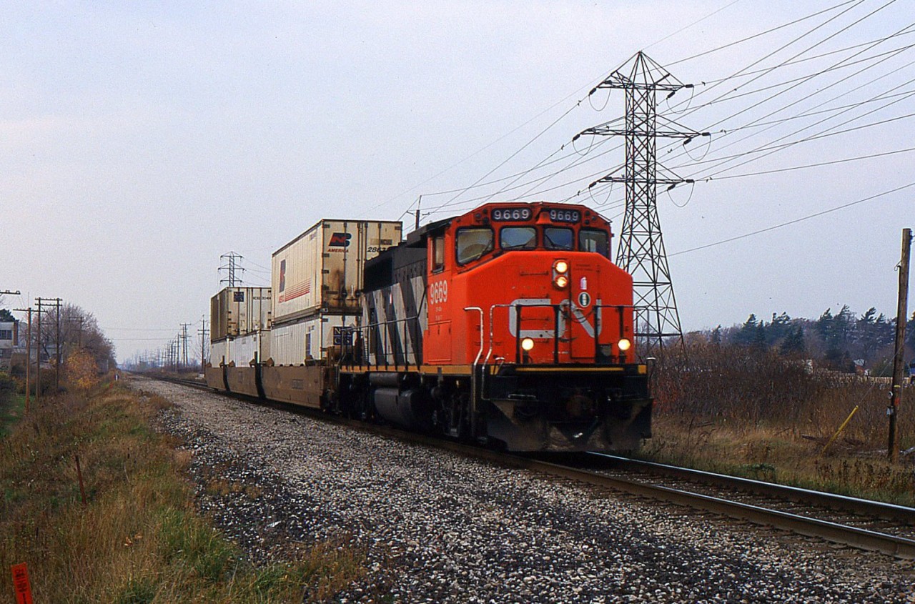 Q15431 with CN 9669 and 3 Well cars from B.I.T. to Buffalo back in 2001.