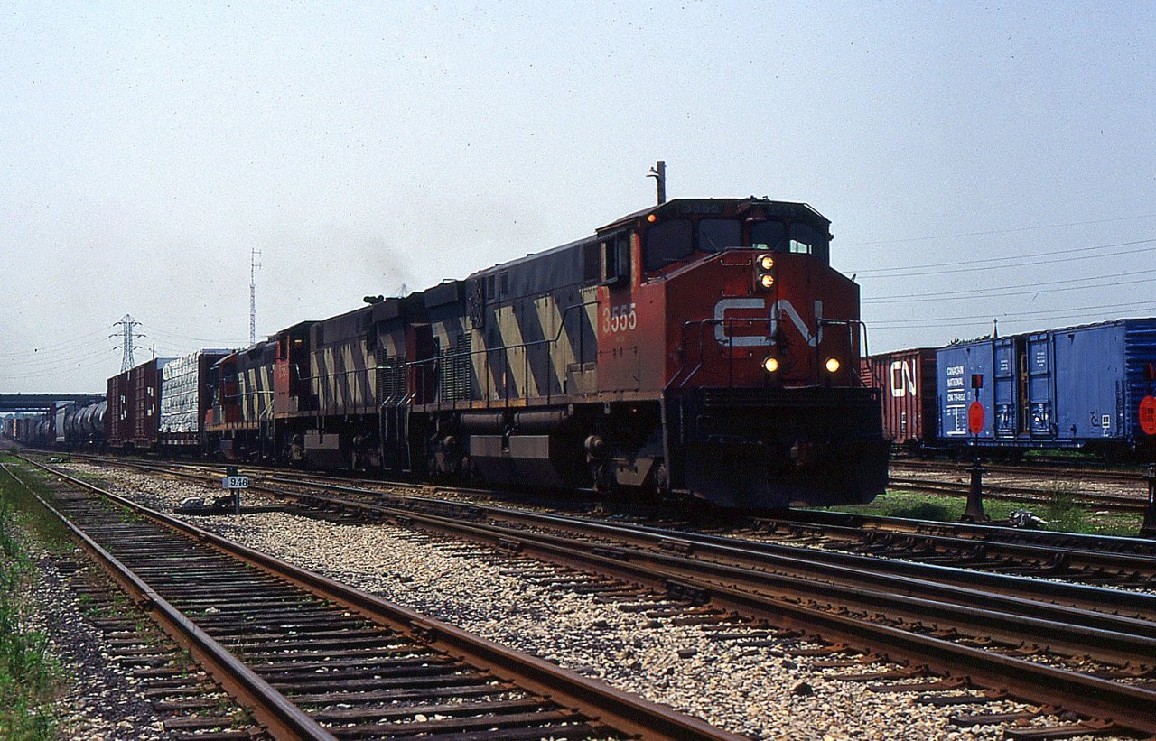 A pair of old CN M-420(w)s and CN GP9RM lead 449 through Merritton on a hot summer day in June 1996.