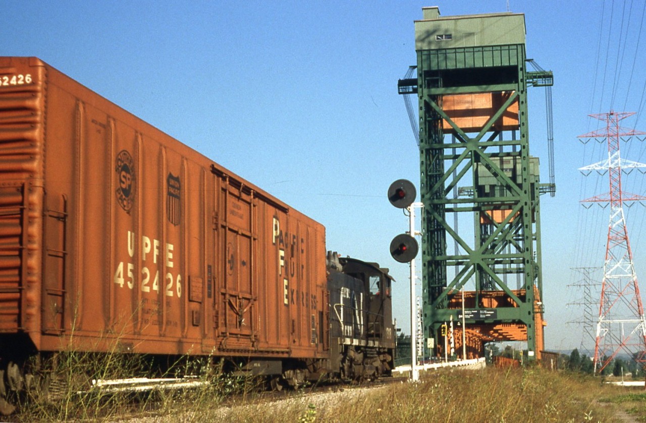 This picture was taken on a warm summer morning on the CN Beach sub as a CN local heads North for the Burlington Canal lift bridge with three Pacific Fruit Express cars and a van in tow.