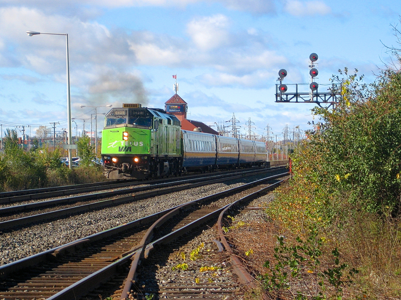 Wrapped for telecommunications company Telus at the time, VIA 6429 leads an eastbound departing Dorval Station back in 2007. In the foreground is the CN/CP interchange track, which was removed a few years later. The signals on the right were replaced by more modern ones a few years back.