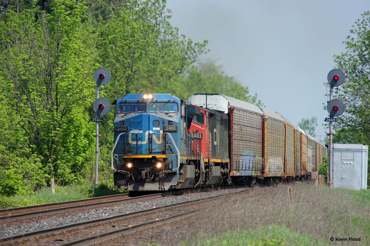 A CN westbound splits the searchlight signals at CN Stewarttown on a muggy May morning. Power was IC 2460-CN 2451.