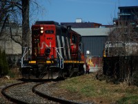 A crewmember has just closed the gate at Ardent Mills after CN 4115 brought three grain cars there.