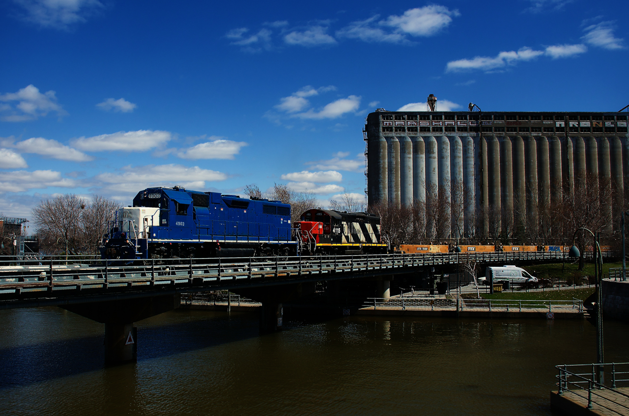 Ex-GMTX CN 4903 & CN 4115 lead a transfer into the Port of Montreal. The water level at the eastern end of the Lachine Canal is quite high.