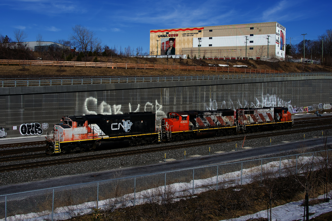 The Pointe St-Charles Switcher has left Taschereau Yard with two new units and is heading back east. CN 9523 will be picked up by CN 527 later that day to be left at Taschereau Yard and CN 4809 and CN 4774 will become the new Pointe St-Charles power.