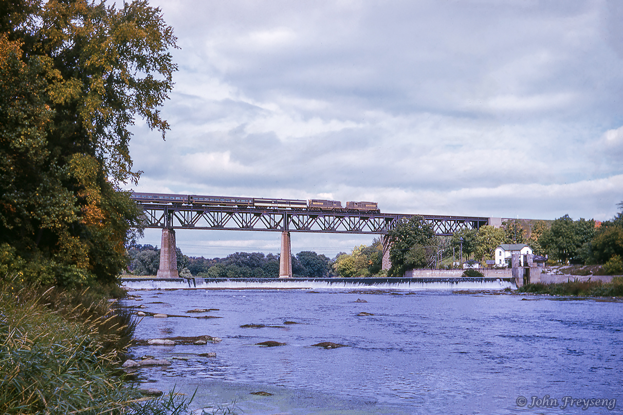 One of southern Ontario's classic scenes.  A pair of Grand Trunk Western GP9s lead eastbound train 6, the Intercity Limited, from Chicago to Toronto.Scan and editing by Jacob Patterson.