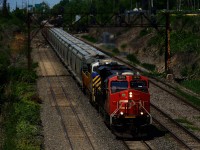 After parking nearby overnight, loaded potash train CN B730 is on the move with a pair of ES44ACs up front.