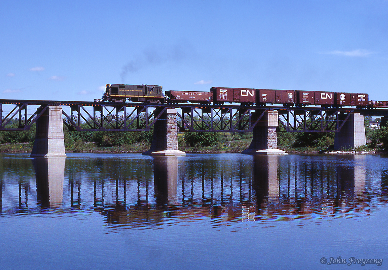 Continuing west from its meet at Canfield, extra 3875 west rumbles across the Grand River at Cayuga.Scan and editing by Jacob Patterson.