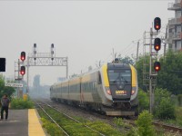 VIA Rail Canada train 28(Ottawa-Montreal-Quebec) consisting of one of the Siemens Venture trainsets now in service(here, cab-coach 2301 on rear and SCV-42 2202 at far end) resumes eastward journey following St Lambert station stop in the heavy smoke conditions in Montreal region, rated the worst in the world Sunday, caused by forest fires in the Abitibi Region of north-west Quebec.