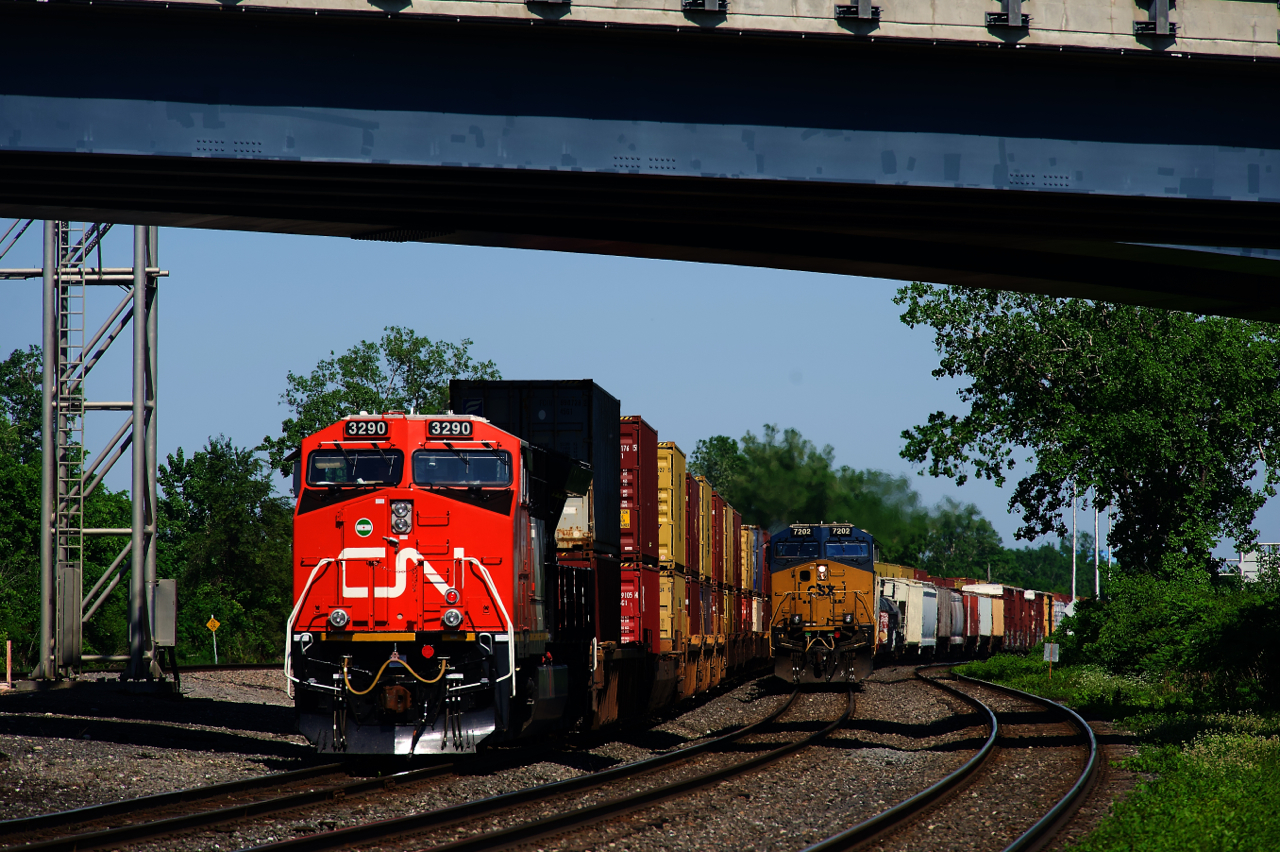 Fresh ET44AC CN 3290 brings up the rear of CN 106 (parked on track DX1) as CN 327 approaches Dorval Station with CSXT 7202 leading.