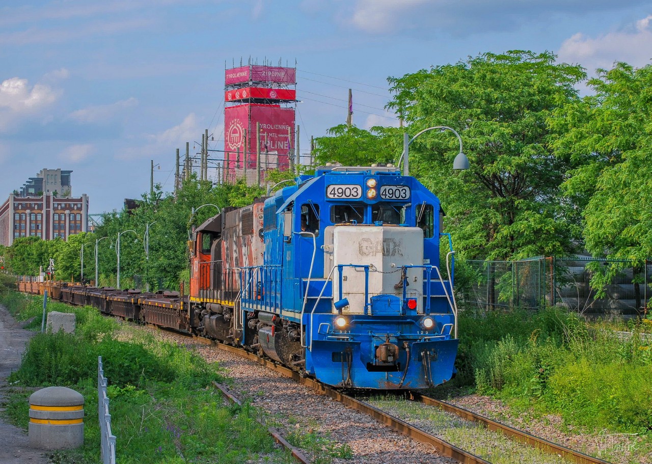 On June 20, 2023, CN 596 has just dropped off various cars at the Port. It is now returning with an empty double-stack train heading for Pointe-Saint-Charles.