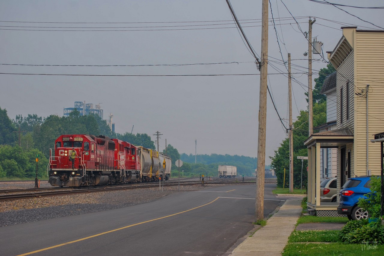 On June 25, 2023, CPKC G20 has just dropped off two grain cars in Farnham Yard and is now preparing to store the rest of its train further north at Mile 8 of the Adirondack Subdivision.