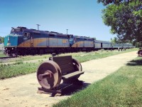 VIA Rail Train 692 headed toward Winnipeg, MB at a stop in Dauphin, MB next to one of the two Dauphin Rail 125 commemorative benches.  Dauphin, MB celebrated 125 years of rail service in 2021 and the benches were placed to commemorate that occasion.