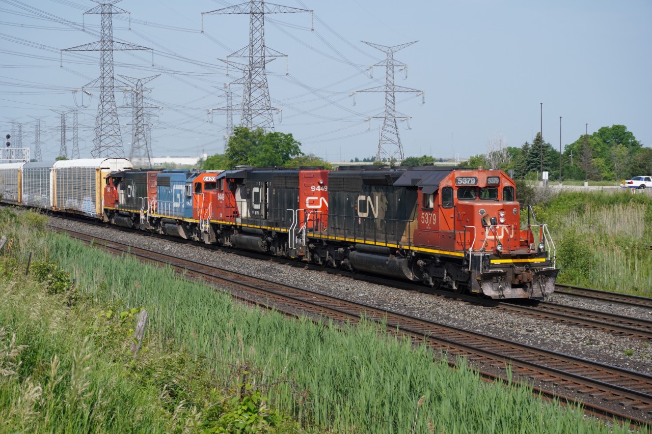 With a cut of autoracks from the Fiat-Chrysler plant, L579 returns back to MacMillan yard with a rare ex-MP SD40-2 in the lead.