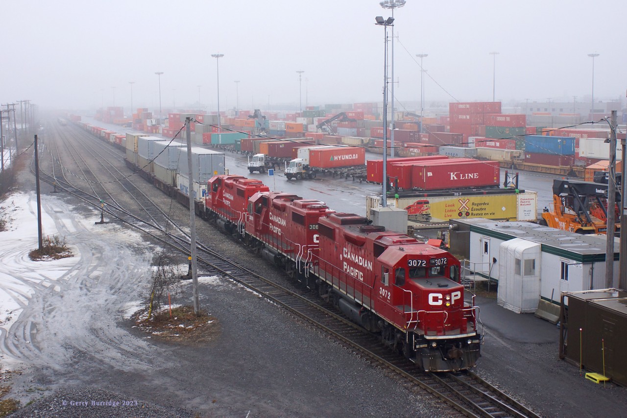 Under a mist-laden sky Canadian Pacific GP35s 3072+3089+3048 are working the intermodal yard at Lachine, Que.