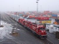 Under a mist-laden sky Canadian Pacific GP35s 3072+3089+3048 are working the intermodal yard at Lachine, Que.