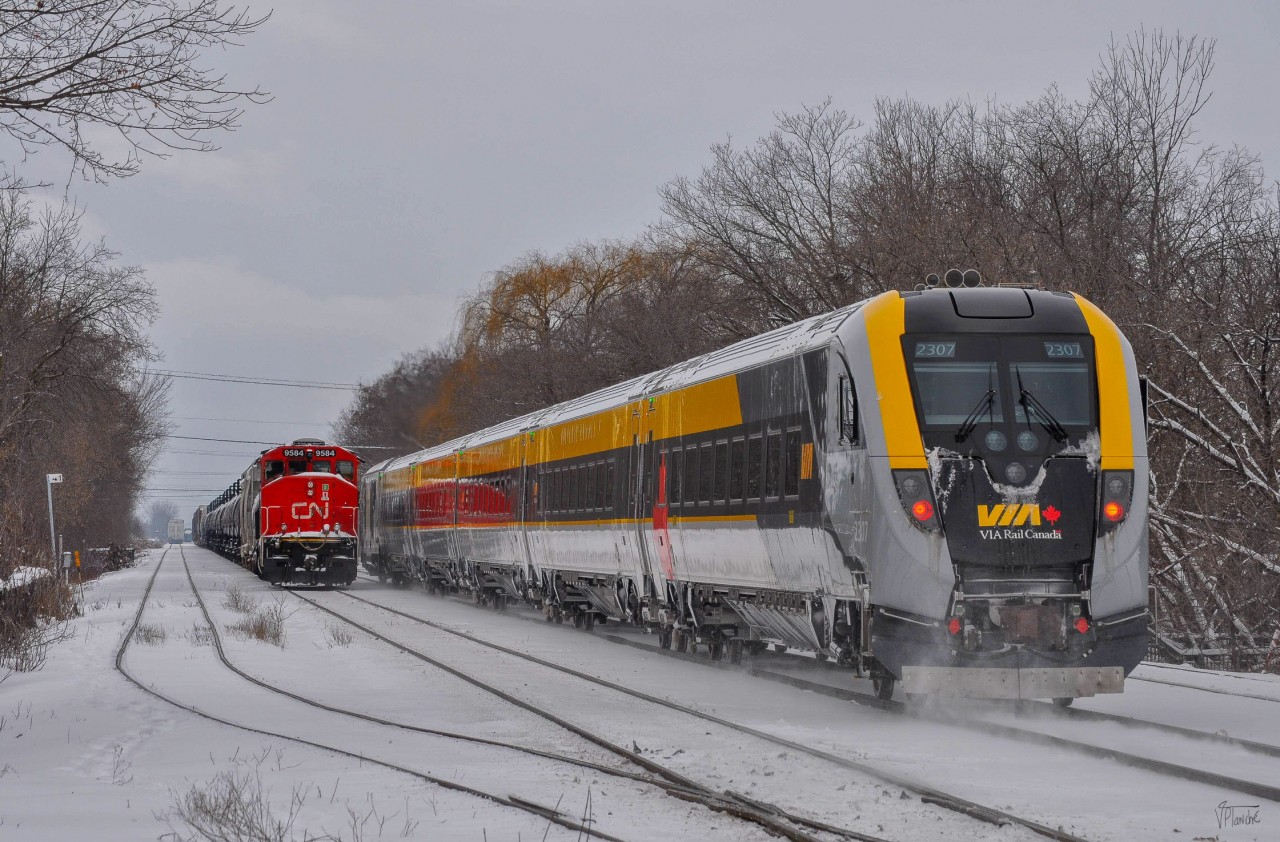 On January 8, 2023, VIA 35 passes CN 519 (Saint-Hyacinthe switcher) working west of the yard.