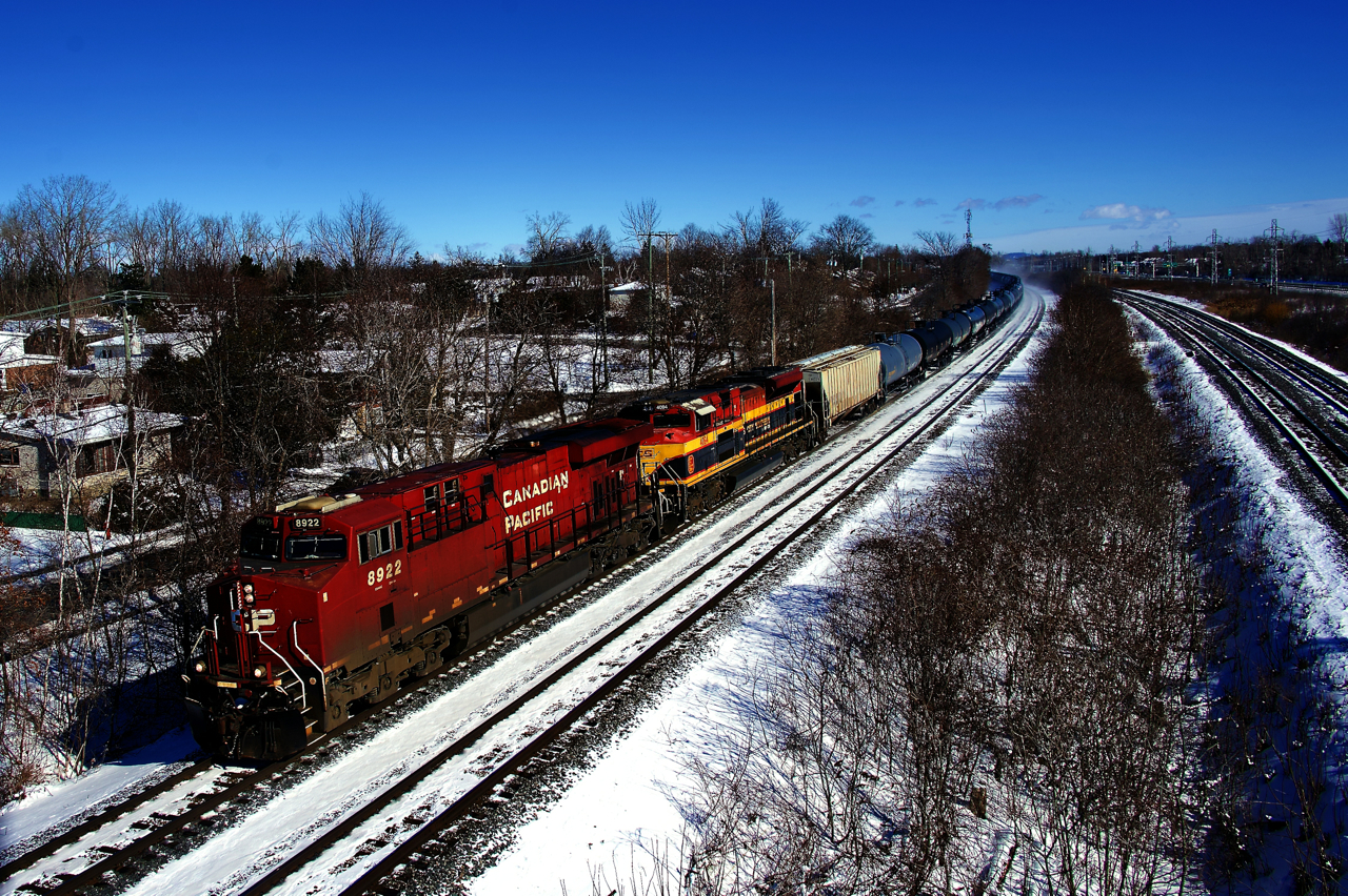 Ethanol empties are heading back west as CPKC 529 rounds a curve a bit past Beaconsfield Station with CP 8922 & KCSM 4094 for power.