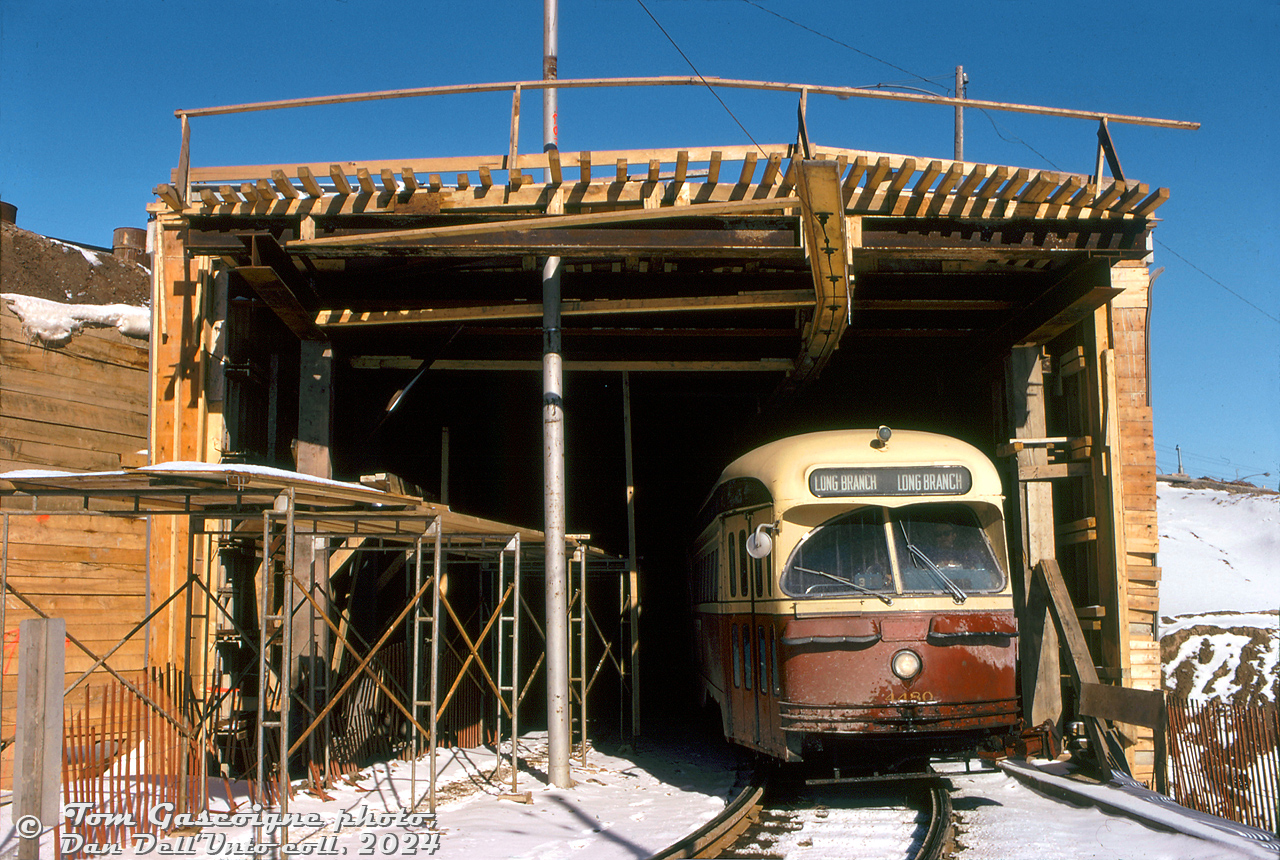 TTC PCC 4480 (A7-class, blt CC&F 1949) pops out from the under-construction Queen Elizabeth Way streetcar tunnel on the private streetcar right-of-way from Humber Loop, about to enter Lake Shore Blvd and head west to Long Branch.The wooden shoring and scaffolding around the QEW and streetcar tunnel was due to this section of the QEW near Swansea being under expansion and realignment in 1973-74, with new lanes added to the south of the existing roadway (requiring extending the existing streetcar tunnel under the new lanes). Streetcars to Long Branch were kept running during the construction period, passing through the tunnel via a single track controlled by traffic lights at both ends (more info and photos can be found at Steve Munro's blog post here).Tom Gascoigne photo, Dan Dell'Unto collection slide.