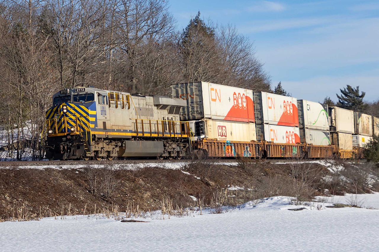 The calm of a sunny winters day is broken by the first of 3 1+1 CN stackers headed west.