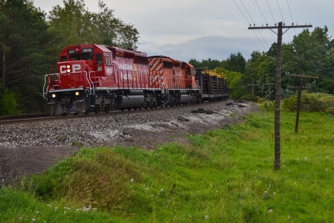 Freshly repainted CP 6012 and sister 5871 lug a heavy welded rail train up the Palgrave hill on a gloomy summer afternoon. CP's recent SD40-2 overhaul program has brought many units, including 6012, out of storage for repairs and a fresh coat of paint courtesy of Progress Rail.