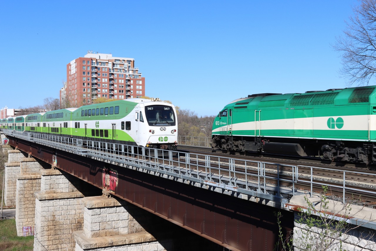 Westbound GO 367 has departed Oakville as eastbound GO 613 passes on the Sixteen Mile Creek bridge for their next station stop at Oakville.