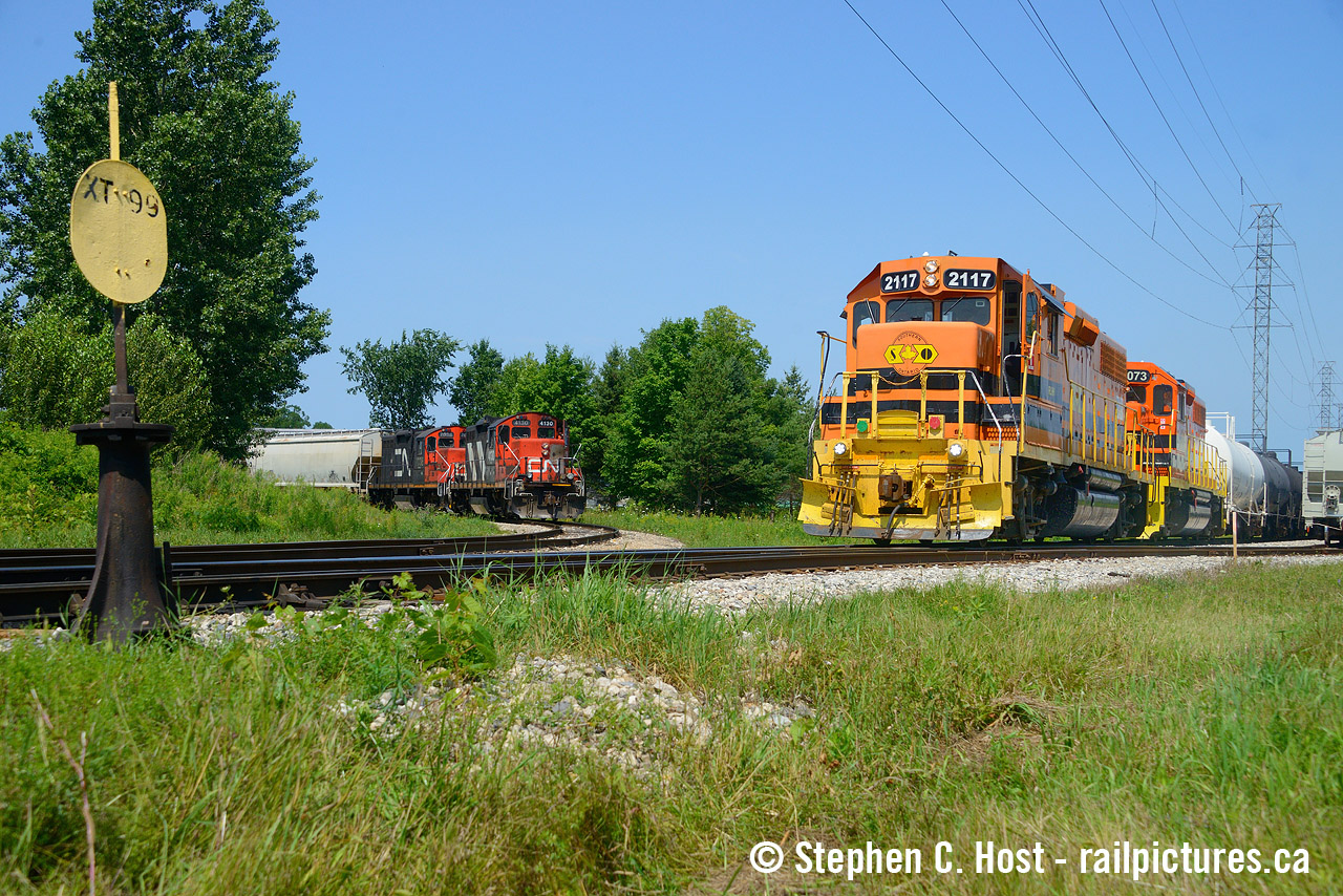 The Guelph Junction Railway, 100% owned by the City of Guelph since 1910 (Prior to that 70%), is jointly serviced in the "North End" of Guelph by both CN and GEXR (vis a vis CPKC). The Guelph Junction entered into a tri-tripartite agreement in 1955 to build industrial spurs to the new Industrial park, which gave CN rights to service the customers in return for 50% of all costs to maintain or expand the railway. In 1998 CN handed their side to GEXR, while GJR handed theirs to OSR both on 20 or so year contracts. Fast forward to today, CN took their side back in November 2018 but GEXR took over GJR in 2020 effectively trading places from their prior duties. 
The focal point of all this action in Guelph is the GJR/CNR interchange tracks, one at Dawson road, and now two, at Edinburgh/Woodlawn along with a wye. Because of this, you'll often find trains riding around the wye like a carousel going round and round to get out of everyone's way and finish their work. Almost daily GEXR 582 and CN L542 will work the north end at the same time. But I've seen as many as three trains here at the same time - sometimes it's CN 580/542/GEXR 582, sometimes it's CN 542/GEXR 582 and 583. There have been times 568 came over to Guelph with hot interchange cars for GJR as well. In July 2023 I got one of my favourite photos of two trains here, both trains "elephant style" with matching engine types, framed with the nearly 100 year old switchstand for XT99. Weeks later, construction would begin on XT99A adding a 2'nd interchange track and if you visit this spot now, you'll basically find a small yard, a testament to the surge of business that's come online on the Guelph Junction since GEXR took it over.