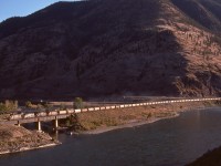 Along the Thompson River just timetable east of Spences Bridge, CP’s Thompson sub. crossed the Nicola River on a straight deck-plate-girder bridge, and on Monday 1977-09-12 at 1756 PDT it was occupied by CN 5141 + 5126 + 5089 + 5274 with eastward grain empties.  While nowadays with a directional running agreement in place in this area it is normal to see CN trains on CP’s track, this was a real variety treat in 1977.

<p>Look closely above about fifteen cars back to see the CP Princeton sub. heading eastward to Merritt, Princeton, and Penticton.
