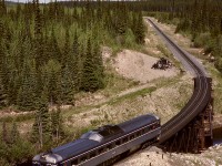 After an overnight stay in Fort St. James, a West Coast Railway Association system tour charter provided a photo run-by with BCOL BC-12 on Monday 1992-06-01 at 1035 PDT at the Muskeg River bridge at mileage 28.3 while enroute the junction with the BC Rail mainline at Odell.  Our destination that day was Fort St. John.
