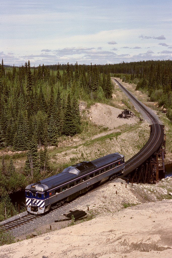 After an overnight stay in Fort St. James, a West Coast Railway Association system tour charter provided a photo run-by with BCOL BC-12 on Monday 1992-06-01 at 1035 PDT at the Muskeg River bridge at mileage 28.3 while enroute the junction with the BC Rail mainline at Odell.  Our destination that day was Fort St. John.