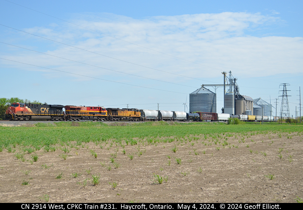 CPKC train #231 rolls through Haycroft, Ontario on May 4th with a mixed batch of power including CN 2914 leading with KCSM 4755 and UP 6249 trailing.