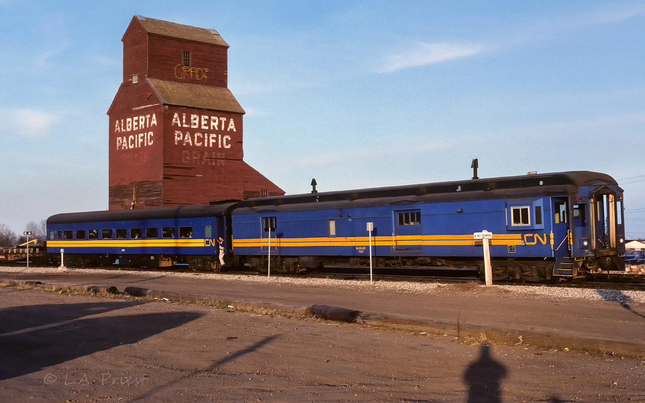 The tail end brakeman was about to give, "that'll do", over the radio. The mixed train was making a stop in Redwater on this evening. There was 35 boy cubs taking a ride from Edmonton to here. In a few minutes, the parking lot was a buzz of excitement as they all de-trained, loudly talking about their ride. In another 15 minutes, all was quiet as they headed back home to Edmonton. What kid doesn't like a train ride? :^) Photo taken at 20:00. Talked with the tail end brakeman for a few minutes afterwards, he was just as revved up as the kids.