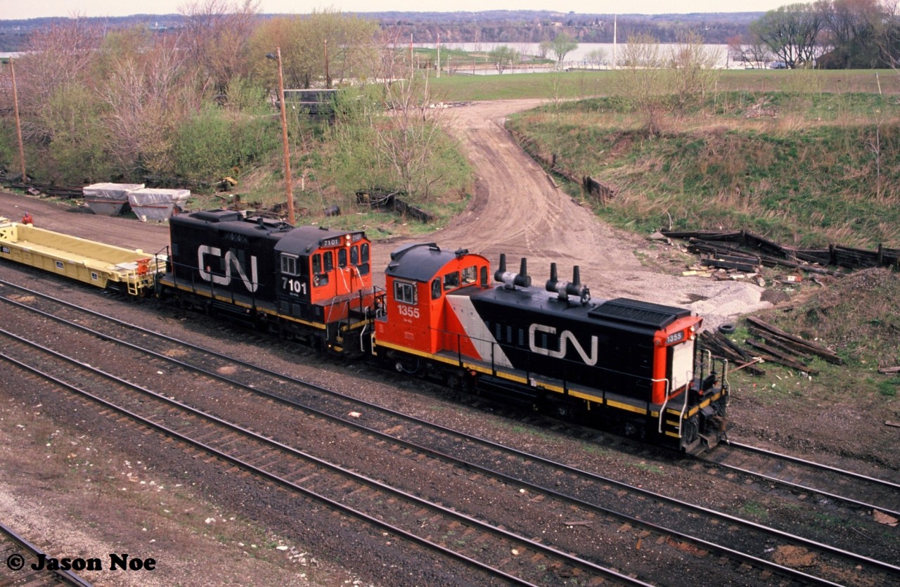 During a slightly overcast spring morning, a CN job is viewed switching Stuart Street Yard in Hamilton, Ontario on the Grimsby Subdivision. CN 1355 and 7101 were sorting newly built DTTX container cars manufactured at the nearby National Steel Car facility.