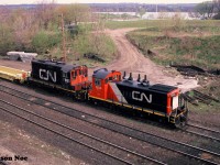 During a slightly overcast spring morning, a CN job is viewed switching Stuart Street Yard in Hamilton, Ontario on the Grimsby Subdivision. CN 1355 and 7101 were sorting newly built DTTX container cars manufactured at the nearby National Steel Car facility.
