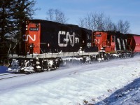 The noodle scheme on a GP9 in the mid-eighties was a tough catch on the Coronado. Plenty of GP38's went by with this paint job, I only saw and photographed 2 GP9's. In May of 1985 the 4368 passed through town and then this photo of the 4283 from 1986. On this day, the 4283 and 4343 were making good speed hauling 25+ grain loads as the train came around the corner at mile 24 that leads to Coronado. It looks like a few wind drifts of snow were driven through on the way home. Cab 79836 on the end, photo time was 11:30.
