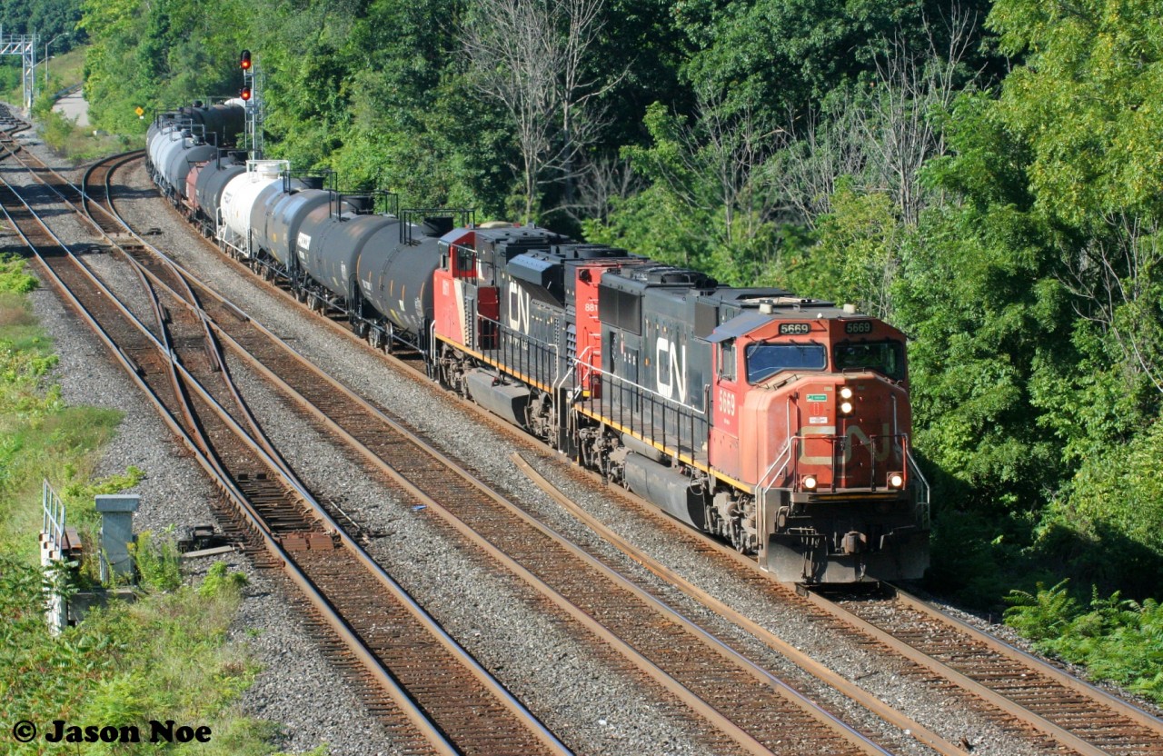 During a summer morning, CN 5669 and 8811 are pictured leading an eastbound off the Dundas Subdivision at Bayview Junction in Burlington, Ontario.