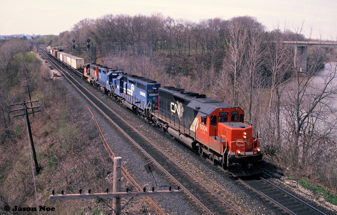 CN "Laser Train" 238 is viewed rolling through Bayview Junction in Burlington, Ontario on the Oakville Subdivision with CN SD40u 6004, Conrail SD40 6261, EMD Leasing GP38-2 790 and a CN GP40-2L(W).