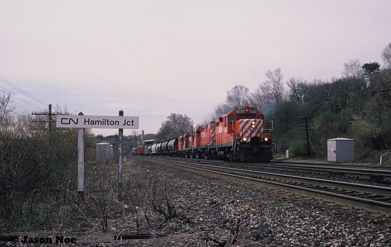 During a spring morning, CP GP9u 8209, RS18u 1831 and another RS18u and GP9u are viewed leading a train onto the CN Oakville Subdivision at Hamilton Junction after having departed CP Aberdeen yard in Hamilton, Ontario. The train will continue eastbound to Toronto over the Oakville Subdivision before reaching CP trackage again at Canpa.