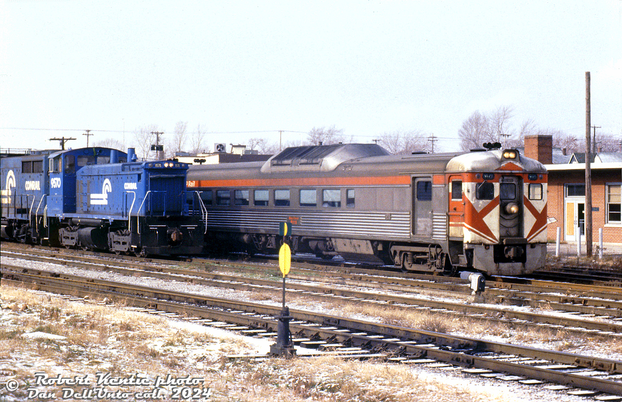 CP Rail RDC-2 9115 and another car are stopped by the station at Fort Erie, handling today's Toronto-Buffalo (ex-CP/TH&B/PC) RDC run now under operation by VIA Rail (some of the ex-CP Budds weren't yet repainted, and operated in full CP paint in early VIA years. They were also maintained by CP shop forces out of John Street roundhouse in Toronto). The train was in its final months of operation, and would be discontinued in April 1981 in favour of the new Amtrak Maple Leaf.

On the next track over, Conrail SW1500 9570 and an unknown GP35 operate on a US-Canada transfer run, likely about to return across the International Bridge into the US.

Robert Kentie photo, Dan Dell'Unto collection slide.