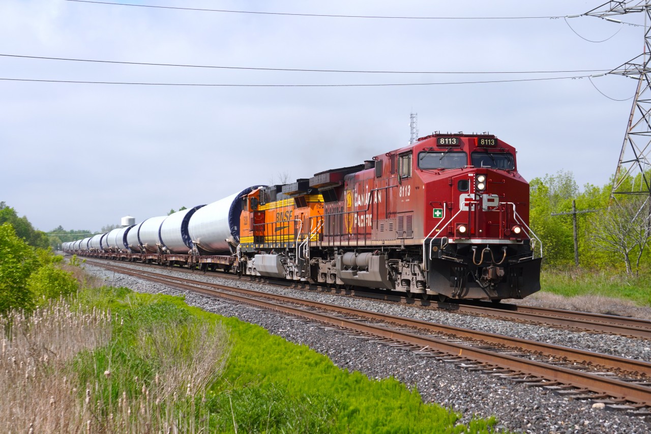 After coming into Agincourt Yard off the Mactier Sub earlier this morning, loaded windmill parts train DIM-08 from Colorado continues through Cherrywood on its way Eastwards to Maine with CP 8113 leading and a repainted Dash-9 BNSF 5228 trailing.