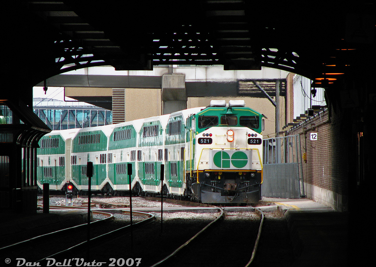 If ever there was a photo summing up commuting on the GO from Union Station in the 2000's, this would be a good contender:

GO Transit F59PH 521 pulls into the dark train shed of Toronto Union Station on Track 1 (Platform 3B in GO parlance) with the afternoon "Bramalea Flip" from Brampton (Bramalea GO to Union). The consist is coming off eastbound #260, arriving just a bit late (pulling in 16 minutes behind its scheduled arrival time of 12:48pm, probably due to grade separation work at the West Toronto diamond). We'd board it, and the train would depart as westbound #263 (the 1 o'clocker flip run to Bramalea) running a bit late, with unrebuilt "ogre eye" cab car 225 on point for the trip west.

Afternoon ridership was still pretty light on the Bramalea Flip at the time (to the point where you could enjoy an entire car to yourself for the whole trip, depending on which and where you boarded), but in a year or two things would pick up. And since it ran outside of rush hours, running the Bramalea Marathon to be first to your car to burn rubber out of the parking lot was not necessary until after 4pm.