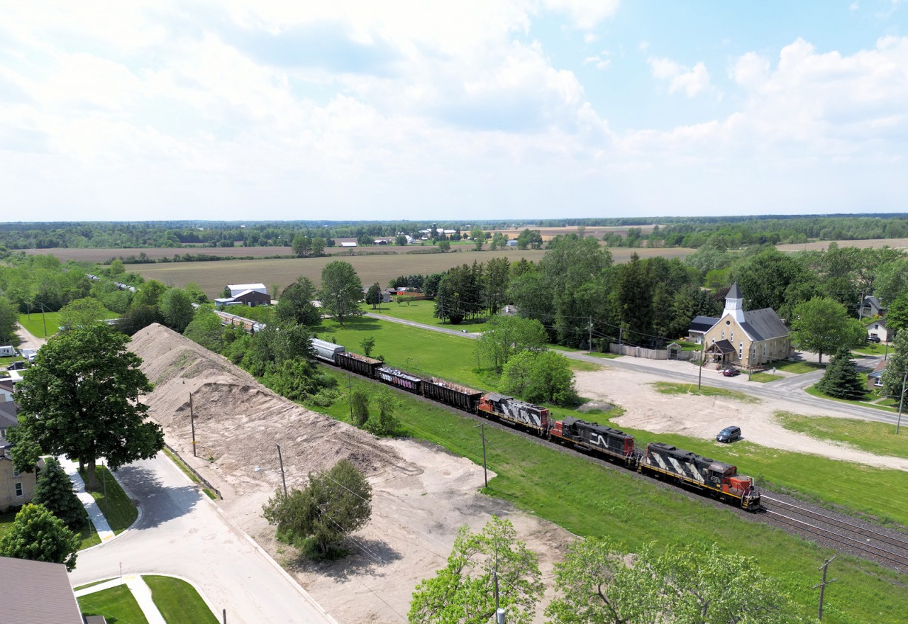 CN's London East, ON to Paris West, ON e/b turn makes a quick stop at Princeton to cut clear of the crossing to service the third customer of the day Stubee's Cement. They will pull four and spot three and then head over to Paris to run around their train and head back to London switching out a fuel transload facility in Woodstock. Several customers in the area take a wide variety of cars, today some CPKC & UP hoppers and scrap metal from Woodstock make up the headend traffic of 23 cars. 

Today this train has GP9rm 4038 + 7038 & GP38-2 4717 provide the power.

May 23, 2024
~MP 37.7 Dundas Subdivision (Princeton, ON)~