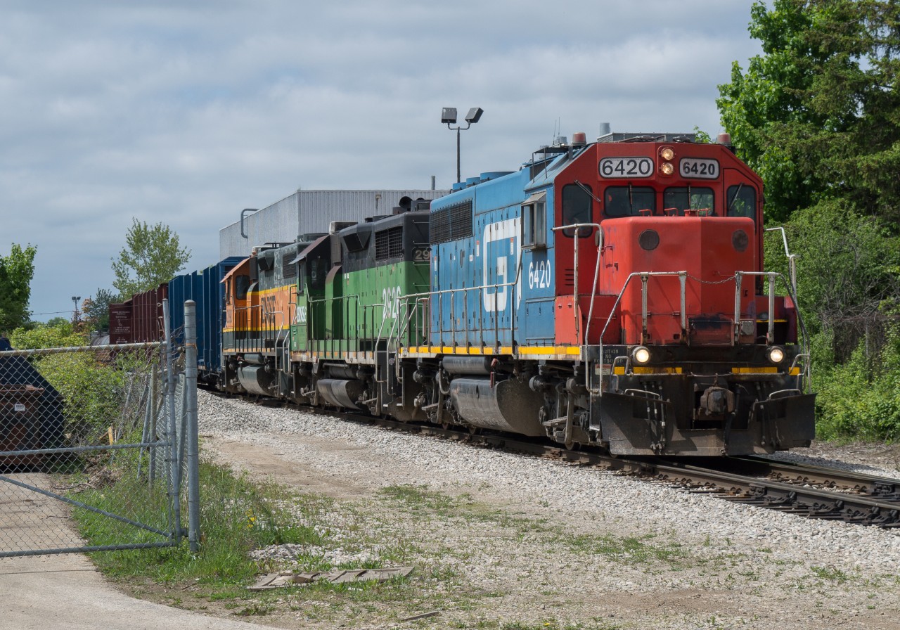 CN L542 makes a reverse move to drop 2 flat cars of rail at PNR Railworks in Guelph.  The power on this day was GTW 6420, BNSF 2926, BNSF 2090 which made for a very colourful consist.