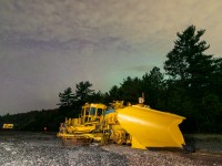 I debated on whether or not to post this one, or whether I should wait to repeat this photo under a more impressive northern lights display, but here you go anyhow! A piece of snowfighting equipment <i>(owned by Mansour, I think? Anyone know reporting marks for this unit?)</i> begins its long summer rest as the fading pillars of a solar storm disappear northward. There was a strong display about a half hour earlier, which I shot above Onaping High Falls.