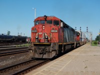 CN Dash8-40CM 2424 and GP40-2L 9424 have intermodal train 148 on the north track past the station at Sarnia, Ontario.